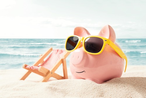Money bank piggy on a beach
